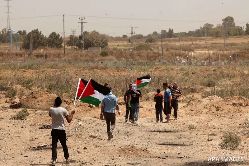 Palestinians take part during a rally to commemorate the "Nakba" or "catastrophe" in Arabic in reference to the establishment in 1948 of the state of Israel near the Nahal Oz crossing east of Gaza City on May 15, 2016. "...