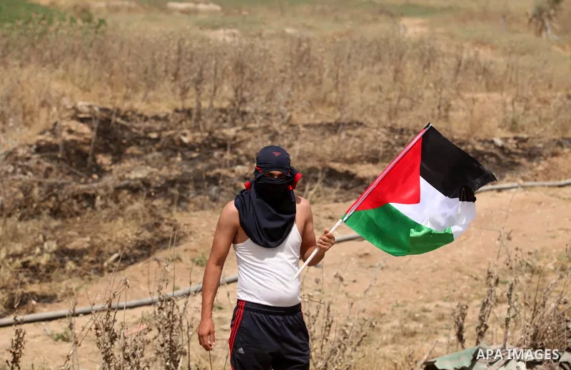 Palestinians take part during a rally to commemorate the "Nakba" or "catastrophe" in Arabic in reference to the establishment in 1948 of the state of Israel near the Nahal Oz crossing east of Gaza City on May 15, 2016. "...