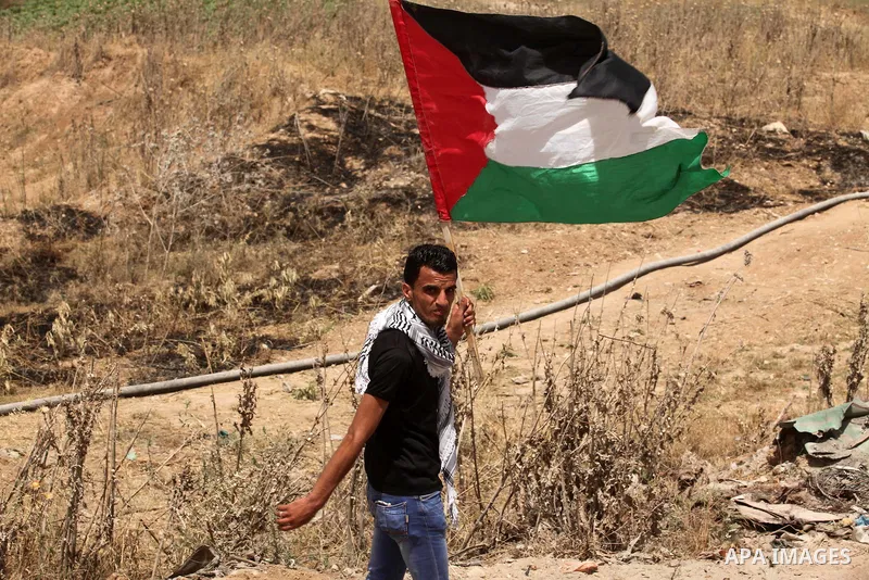 Palestinians take part during a rally to commemorate the "Nakba" or "catastrophe" in Arabic in reference to the establishment in 1948 of the state of Israel near the Nahal Oz crossing east of Gaza City on May 15, 2016. "...