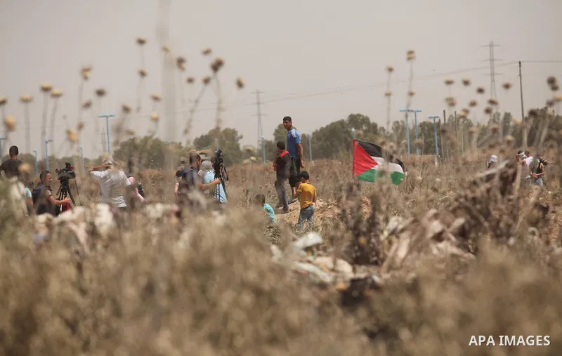 Palestinians take part during a rally to commemorate the "Nakba" or "catastrophe" in Arabic in reference to the establishment in 1948 of the state of Israel near the Nahal Oz crossing east of Gaza City on May 15, 2016. "...