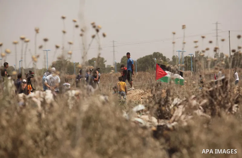 Palestinians take part during a rally to commemorate the "Nakba" or "catastrophe" in Arabic in reference to the establishment in 1948 of the state of Israel near the Nahal Oz crossing east of Gaza City on May 15, 2016. "...