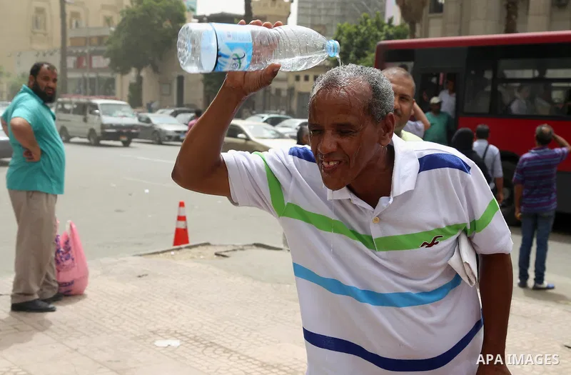 An Egyptian man reacts as he splashes water on his head during a sweltering heat wave, in Cairo, Egypt, on May 15, 2016. Photo by Amr Sayed
