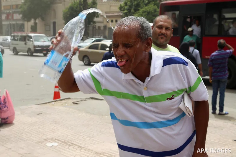 An Egyptian man reacts as he splashes water on his head during a sweltering heat wave, in Cairo, Egypt, on May 15, 2016. Photo by Amr Sayed
