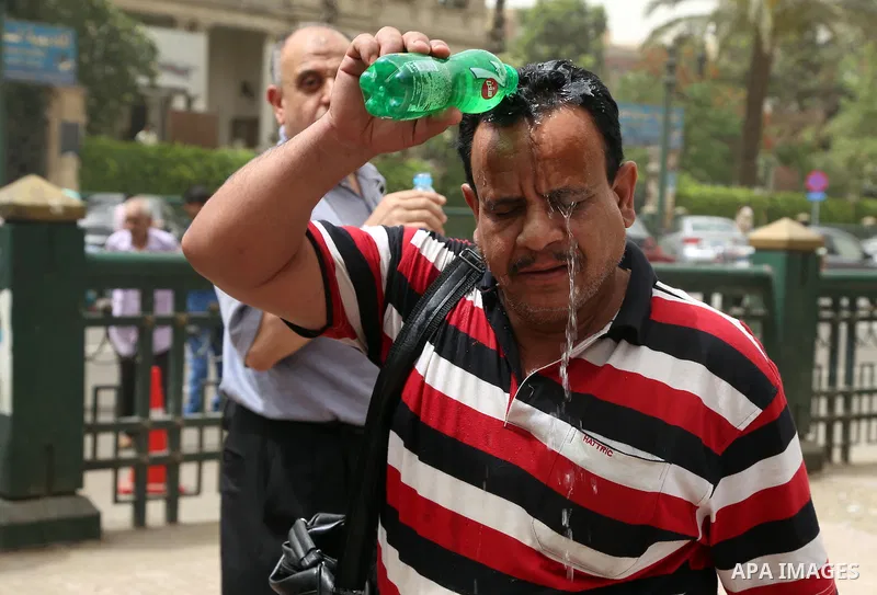 An Egyptian man reacts as he splashes water on his head during a sweltering heat wave, in Cairo, Egypt, on May 15, 2016. Photo by Amr Sayed