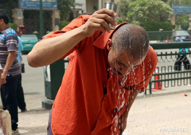 An Egyptian man reacts as he splashes water on his head during a sweltering heat wave, in Cairo, Egypt, on May 15, 2016. Photo by Amr Sayed