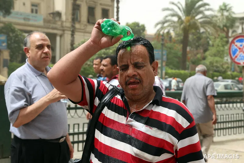 An Egyptian man reacts as he splashes water on his head during a sweltering heat wave, in Cairo, Egypt, on May 15, 2016. Photo by Amr Sayed