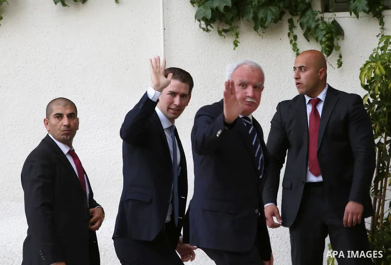 Palestinian Foreign Minister Riyad al-Maliki waves to media as Austrian Foreign Minister Sebastian Kurz arrives to meet Palestinian President Mahmoud Abbas in the West Bank city of Ramallah May 15, 2016. Photo by Shadi H...