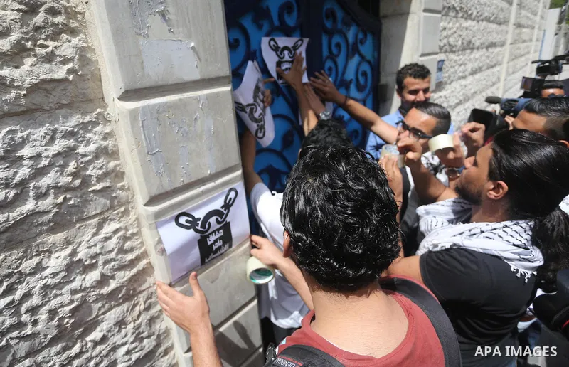 Palestinian activists of Intifada youth coalition, close the gate of "UNDP" during a protest to commemorate the "Nakba" or "catastrophe" in Arabic in reference to the establishment in 1948 of the state of Israel, in Gaza...
