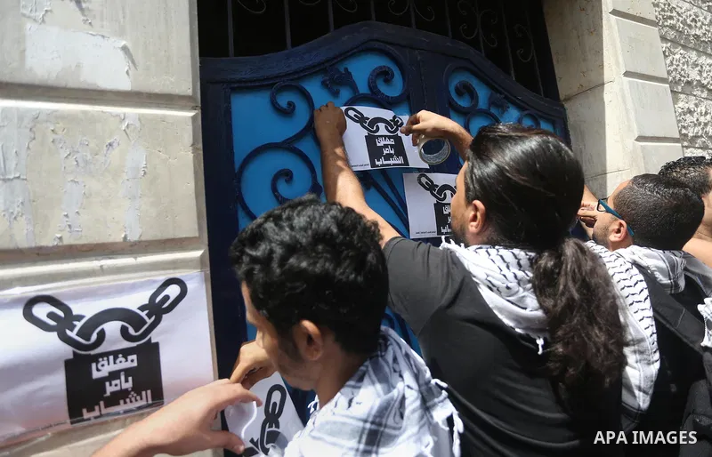 Palestinian activists of Intifada youth coalition, close the gate of "UNDP" during a protest to commemorate the "Nakba" or "catastrophe" in Arabic in reference to the establishment in 1948 of the state of Israel, in Gaza...