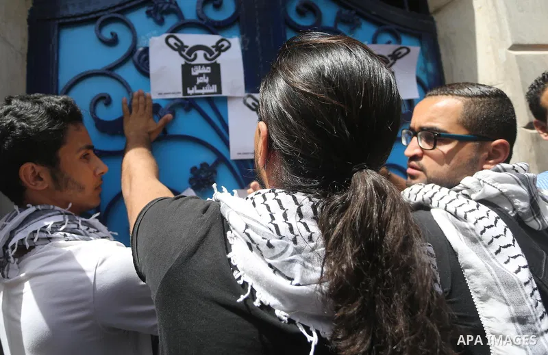 Palestinian activists of Intifada youth coalition, close the gate of "UNDP" during a protest to commemorate the "Nakba" or "catastrophe" in Arabic in reference to the establishment in 1948 of the state of Israel, in Gaza...