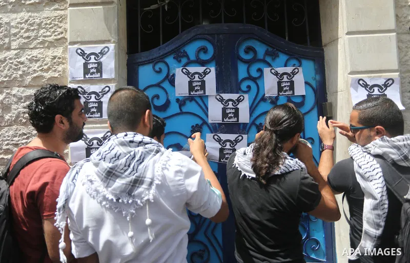 Palestinian activists of Intifada youth coalition, close the gate of "UNDP" during a protest to commemorate the "Nakba" or "catastrophe" in Arabic in reference to the establishment in 1948 of the state of Israel, in Gaza...