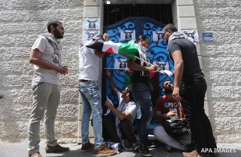 Palestinian activists of Intifada youth coalition, close the gate of "UNDP" during a protest to commemorate the "Nakba" or "catastrophe" in Arabic in reference to the establishment in 1948 of the state of Israel, in Gaza...