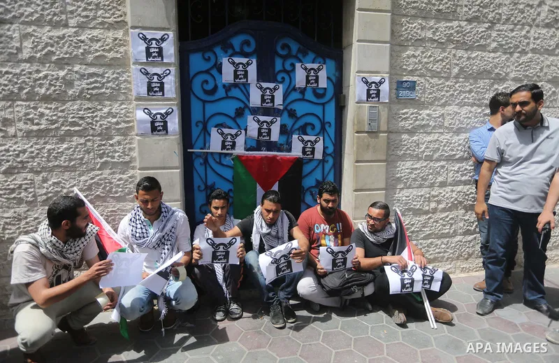Palestinian activists of Intifada youth coalition, close the gate of "UNDP" during a protest to commemorate the "Nakba" or "catastrophe" in Arabic in reference to the establishment in 1948 of the state of Israel, in Gaza...