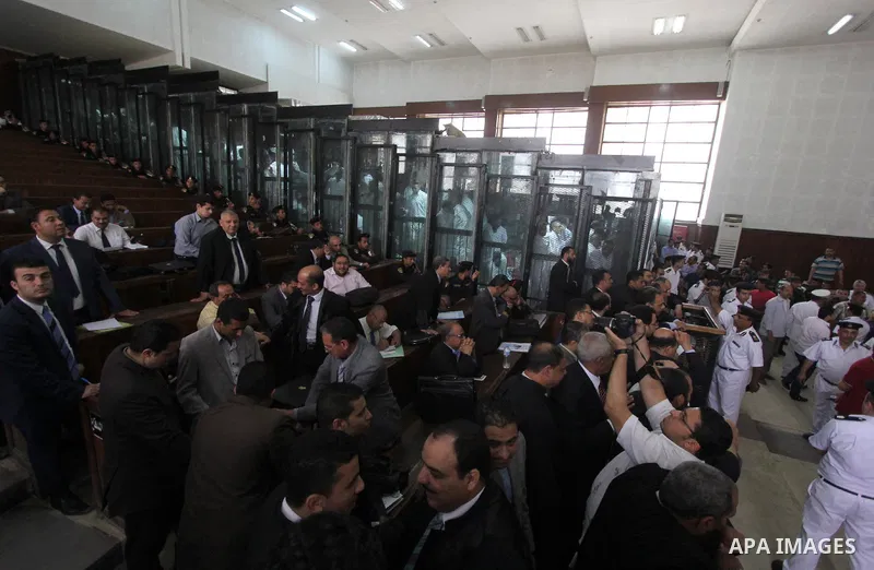 Egyptian Muslim Brotherhood members stand inside the defendants cage during their trial in the capital Cairo on May 17, 2016. Photo by Amr Sayed
