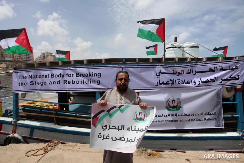 Palestinian patients take part during a protest demanding for treatment abroad, at the Seaport of Gaza City on May 18, 2016. Photo by Ashraf Amra