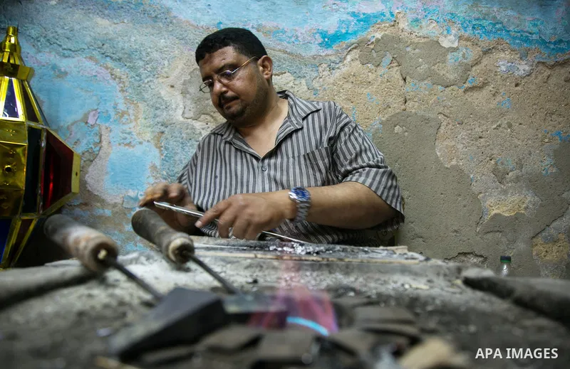 An Egyptian worker manufactures a traditional Ramadan lantern known as "Fanous" in Arabic, at his workshop ready for the month of holy Ramadan in cairo, Egypt, on May 18, 2016. Photo by Amr Sayed