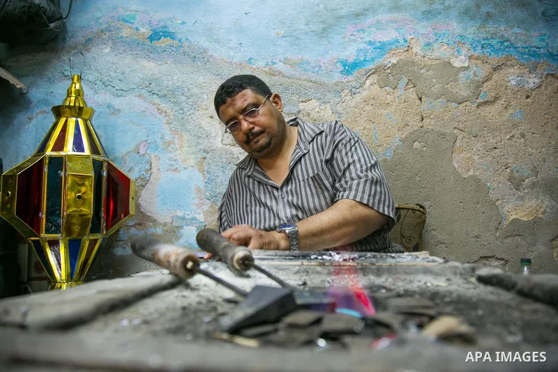An Egyptian worker manufactures a traditional Ramadan lantern known as "Fanous" in Arabic, at his workshop ready for the month of holy Ramadan in cairo, Egypt, on May 18, 2016. Photo by Amr Sayed