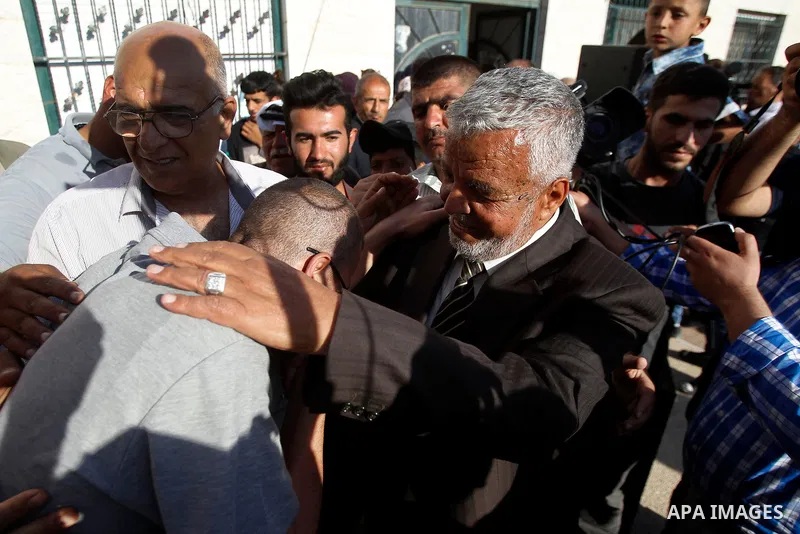 Palestinian imprisoned journalist, Mohammed al-Qiq hugs his father as he arrives in his village Dura, in southern West Bank after he was released from the Israeli Nafha Prison on May 19, 2016. Mohammed al-Qiq, 33, held b...
