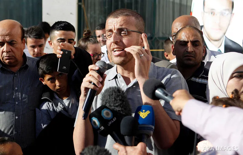 Palestinian imprisoned journalist, Mohammed al-Qiq hugs his father as he arrives in his village Dura, in southern West Bank after he was released from the Israeli Nafha Prison on May 19, 2016. Mohammed al-Qiq, 33, held b...