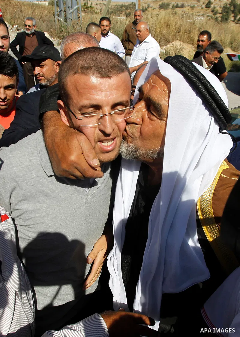 Palestinian imprisoned journalist, Mohammed al-Qiq hugs his father as he arrives in his village Dura, in southern West Bank after he was released from the Israeli Nafha Prison on May 19, 2016. Mohammed al-Qiq, 33, held b...