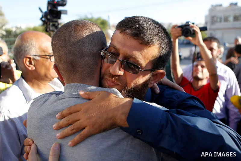Palestinian imprisoned journalist, Mohammed al-Qiq hugs his father as he arrives in his village Dura, in southern West Bank after he was released from the Israeli Nafha Prison on May 19, 2016. Mohammed al-Qiq, 33, held b...