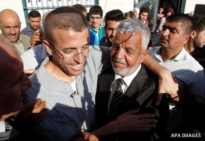 Palestinian imprisoned journalist, Mohammed al-Qiq hugs his father as he arrives in his village Dura, in southern West Bank after he was released from the Israeli Nafha Prison on May 19, 2016. Mohammed al-Qiq, 33, held b...