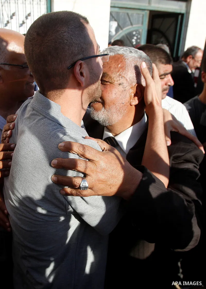 Palestinian imprisoned journalist, Mohammed al-Qiq hugs his father as he arrives in his village Dura, in southern West Bank after he was released from the Israeli Nafha Prison on May 19, 2016. Mohammed al-Qiq, 33, held b...