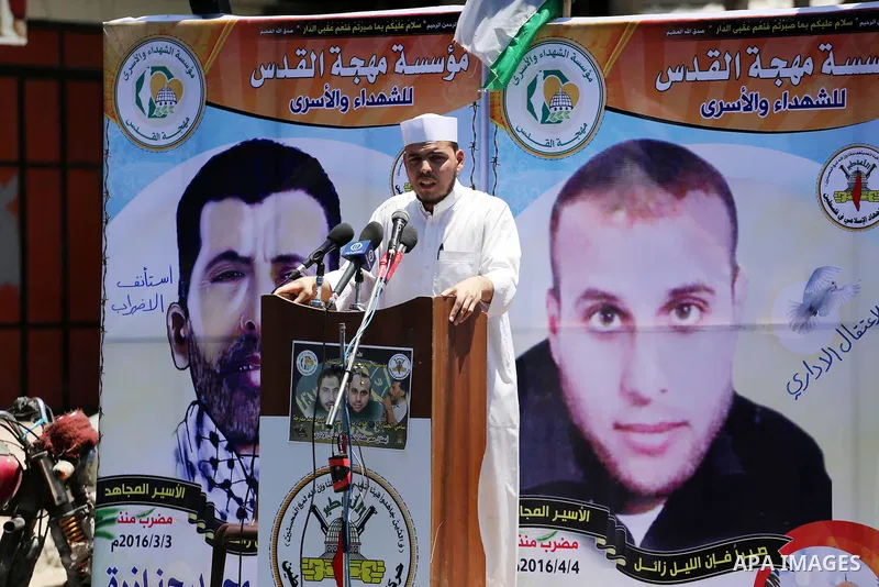 Palestinian supporters of the Islamic Jihad Movement attend Friday prayers to show solidarity with Palestinian prisoners in Israeli Jails, in front of Red cross office in Gaza city, on May 20, 2016. Photo by Mohammed Asa...