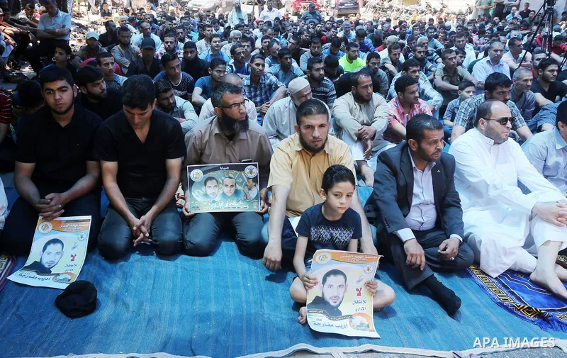 Palestinian supporters of the Islamic Jihad Movement attend Friday prayers to show solidarity with Palestinian prisoners in Israeli Jails, in front of Red cross office in Gaza city, on May 20, 2016. Photo by Mohammed Asa...