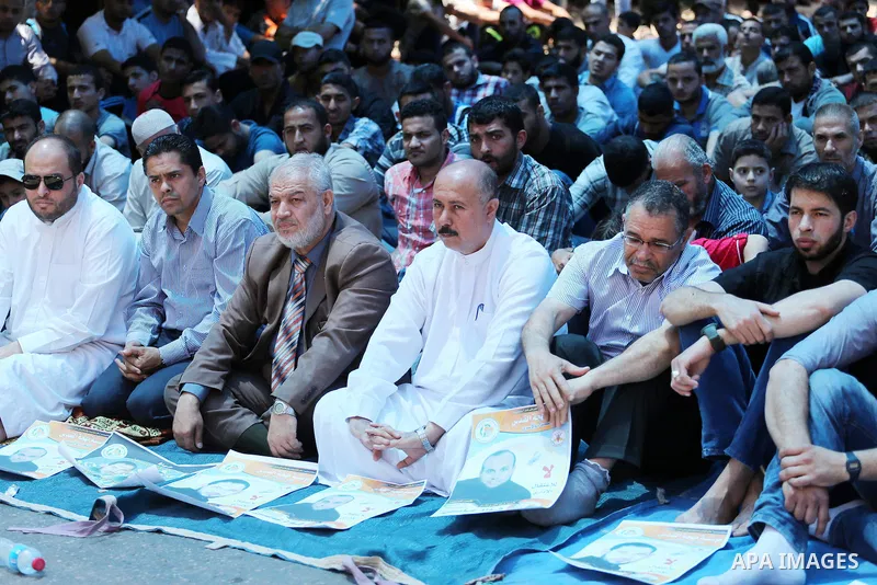 Palestinian supporters of the Islamic Jihad Movement attend Friday prayers to show solidarity with Palestinian prisoners in Israeli Jails, in front of Red cross office in Gaza city, on May 20, 2016. Photo by Mohammed Asa...