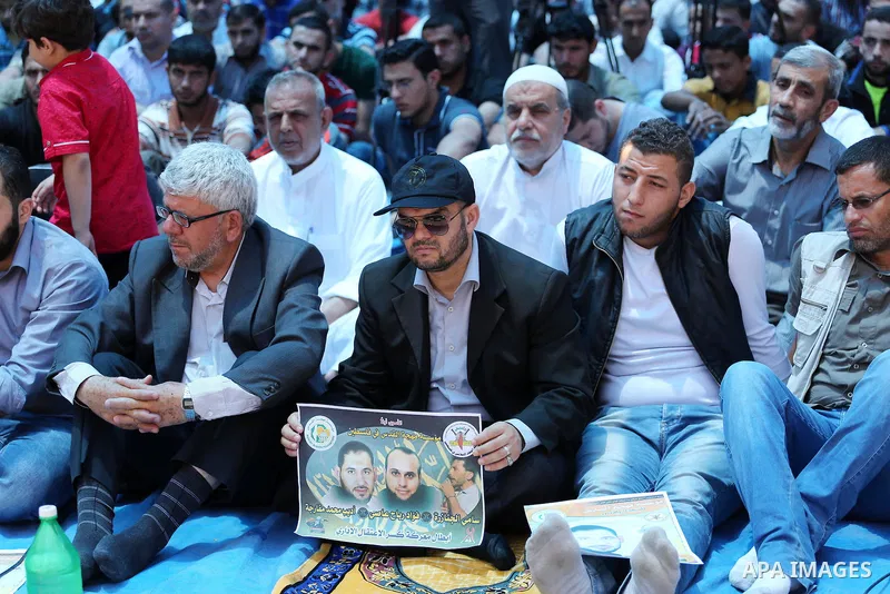 Palestinian supporters of the Islamic Jihad Movement attend Friday prayers to show solidarity with Palestinian prisoners in Israeli Jails, in front of Red cross office in Gaza city, on May 20, 2016. Photo by Mohammed Asa...