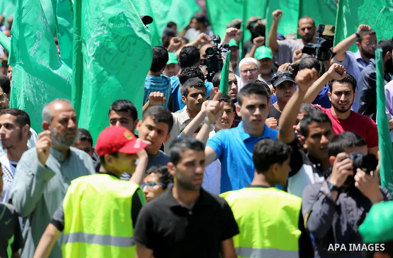 Palestinian supporters of the Islamist movement Hamas take part during a rally to commemorate the 68th anniversary of the "Nakba" or "catastrophe" in Arabic in reference to the establishment in 1948 of the state of Israe...