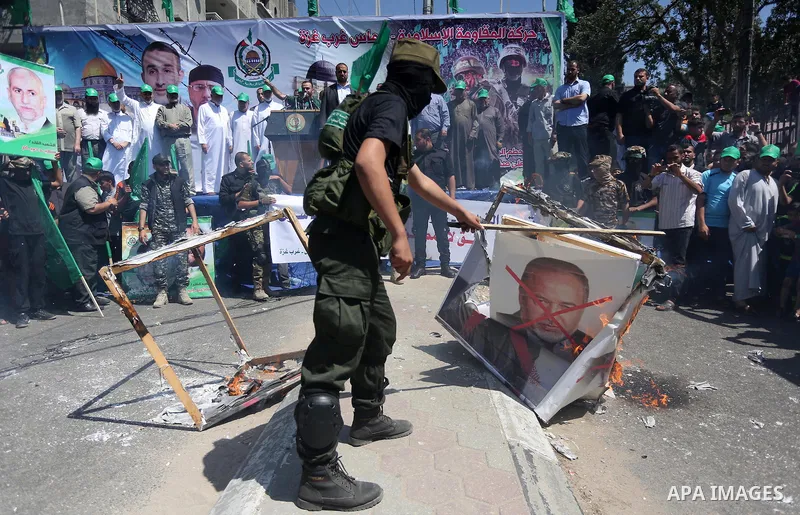 Palestinian supporters of the Islamist movement Hamas take part during a rally to commemorate the 68th anniversary of the "Nakba" or "catastrophe" in Arabic in reference to the establishment in 1948 of the state of Israe...