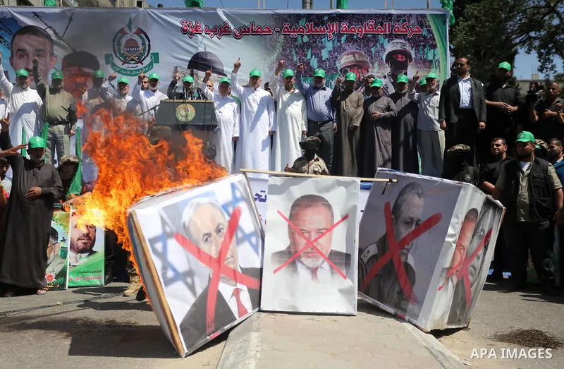 Palestinian supporters of the Islamist movement Hamas take part during a rally to commemorate the 68th anniversary of the "Nakba" or "catastrophe" in Arabic in reference to the establishment in 1948 of the state of Israe...