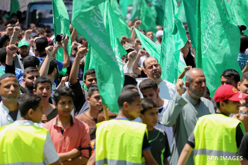 Palestinian supporters of the Islamist movement Hamas take part during a rally to commemorate the 68th anniversary of the "Nakba" or "catastrophe" in Arabic in reference to the establishment in 1948 of the state of Israe...