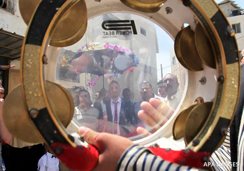 Palestinian friends and relatives celebrated the groom, Mahran Abu Rish, in the West Bank city of Nablus on the eve of his wedding on May 21, 2016, during the traditional celebration, Abu Rish, was first taken by relativ...