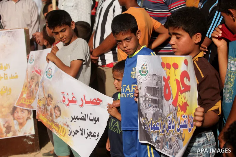 Palestinian children hold placards during a protest against the Israeli blockade of the Gaza Strip and demanding for reconstruction of houses which were destroyed during the recent Israeli war in Biet Hanoun in the north...