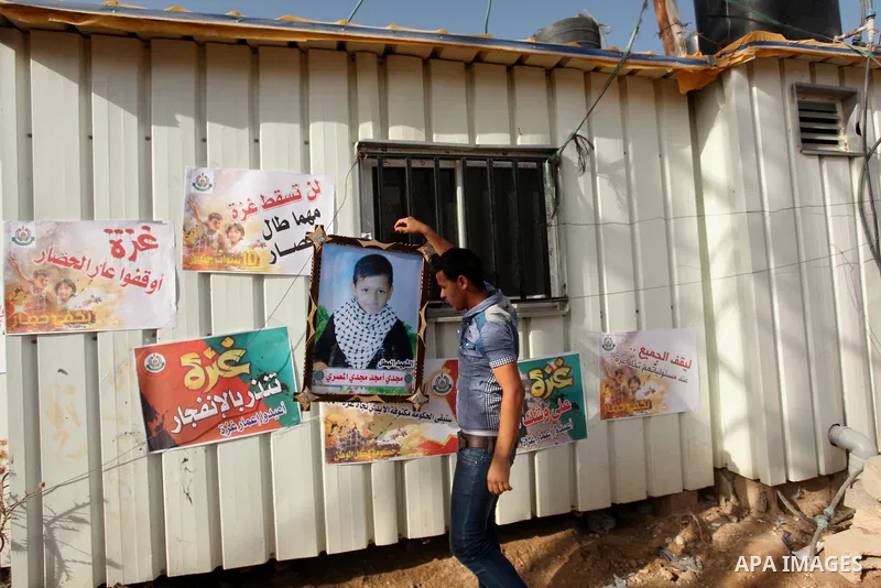 Palestinian children hold placards during a protest against the Israeli blockade of the Gaza Strip and demanding for reconstruction of houses which were destroyed during the recent Israeli war in Biet Hanoun in the north...