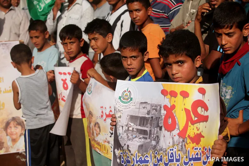 Palestinian children hold placards during a protest against the Israeli blockade of the Gaza Strip and demanding for reconstruction of houses which were destroyed during the recent Israeli war in Biet Hanoun in the north...