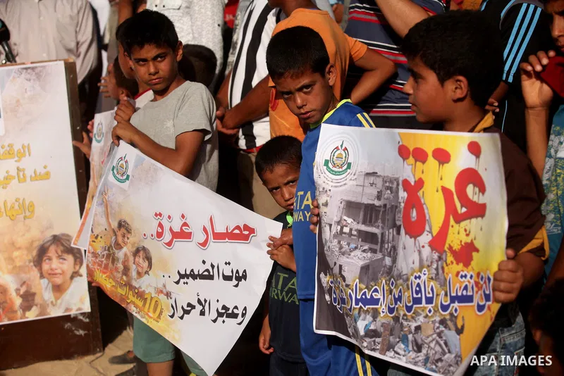Palestinian children hold placards during a protest against the Israeli blockade of the Gaza Strip and demanding for reconstruction of houses which were destroyed during the recent Israeli war in Biet Hanoun in the north...