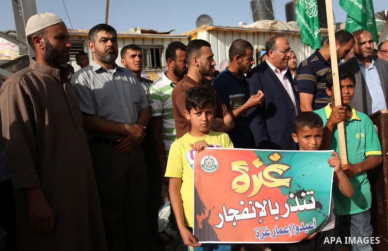 Palestinian children hold placards during a protest against the Israeli blockade of the Gaza Strip and demanding for reconstruction of houses which were destroyed during the recent Israeli war in Biet Hanoun in the north...
