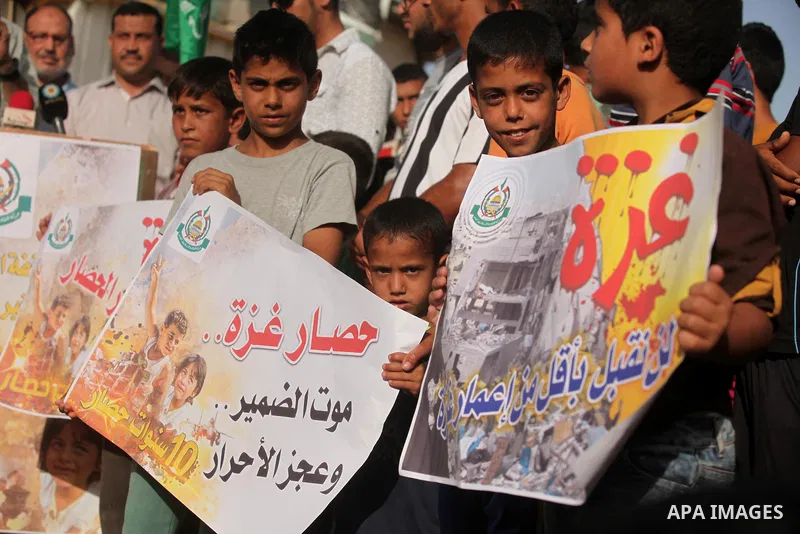 Palestinian children hold placards during a protest against the Israeli blockade of the Gaza Strip and demanding for reconstruction of houses which were destroyed during the recent Israeli war in Biet Hanoun in the north...