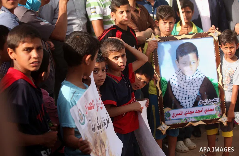 Palestinian children hold placards during a protest against the Israeli blockade of the Gaza Strip and demanding for reconstruction of houses which were destroyed during the recent Israeli war in Biet Hanoun in the north...