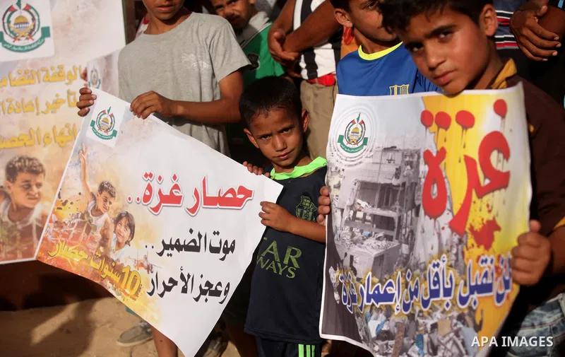 Palestinian children hold placards during a protest against the Israeli blockade of the Gaza Strip and demanding for reconstruction of houses which were destroyed during the recent Israeli war in Biet Hanoun in the north...