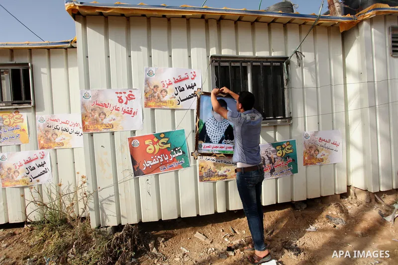Palestinian children hold placards during a protest against the Israeli blockade of the Gaza Strip and demanding for reconstruction of houses which were destroyed during the recent Israeli war in Biet Hanoun in the north...