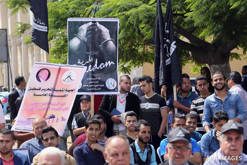 Palestinians gather during a rally marking the 51th anniversary of the Popular Front for the Liberation of Palestine (General Command),in front of Red cross office, in Gaza city, on May 23, 2016. Photo by Mohammed Asad