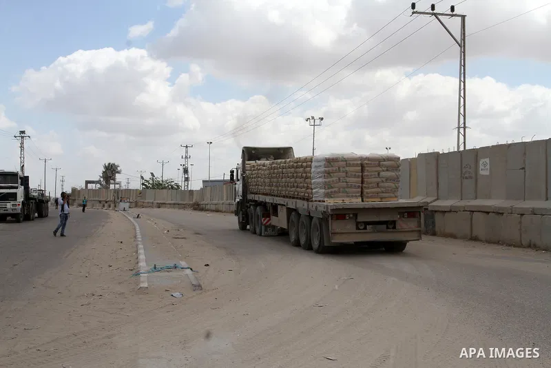 Loaded trucks cross the Kerem Shalom crossing to Rafah in southern Gaza Strip on May 23, 2016. Israel said on May 22 it was lifting a ban imposed last month on private imports of cement to the Hamas-run Gaza Strip. The b...