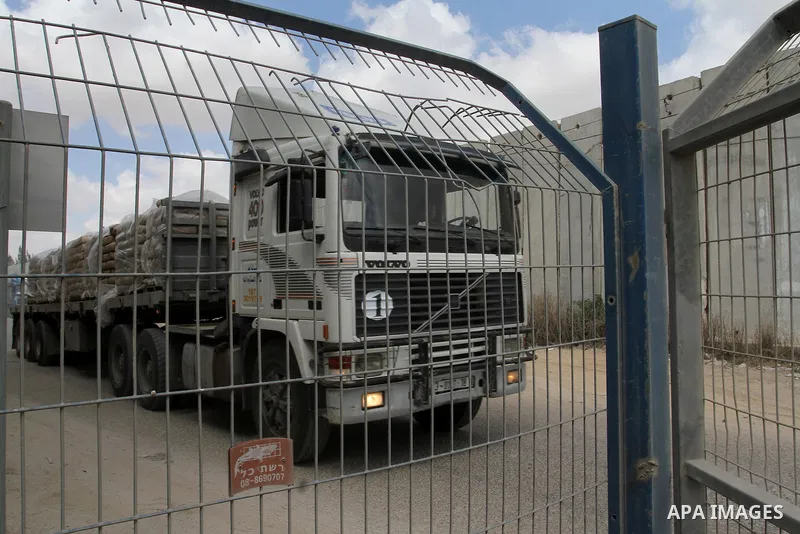 Loaded trucks cross the Kerem Shalom crossing to Rafah in southern Gaza Strip on May 23, 2016. Israel said on May 22 it was lifting a ban imposed last month on private imports of cement to the Hamas-run Gaza Strip. The b...