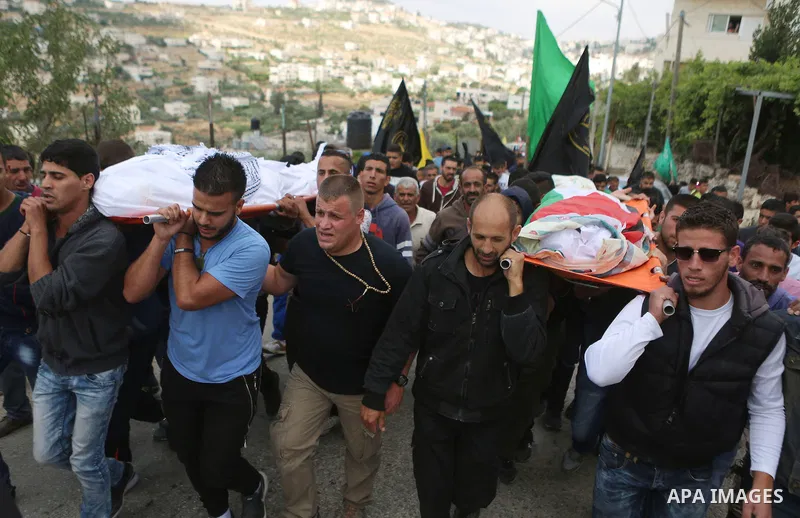 Mourners carry the bodies of Palestinian woman Maram Abu Ismail and her brother Ibrahim Taha, who were shot dead by Israeli police last month, during their funeral near the West Bank city of Ramallah May 23, 2016. Photo...