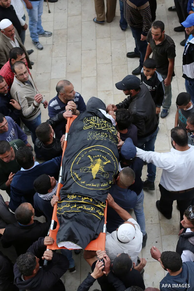 Mourners carry the body of Palestinian woman Maram Abu Ismail, who was shot dead by Israeli police along with her brother last month, during their funeral near the West Bank city of Ramallah May 23, 2016. Photo by Shadi...